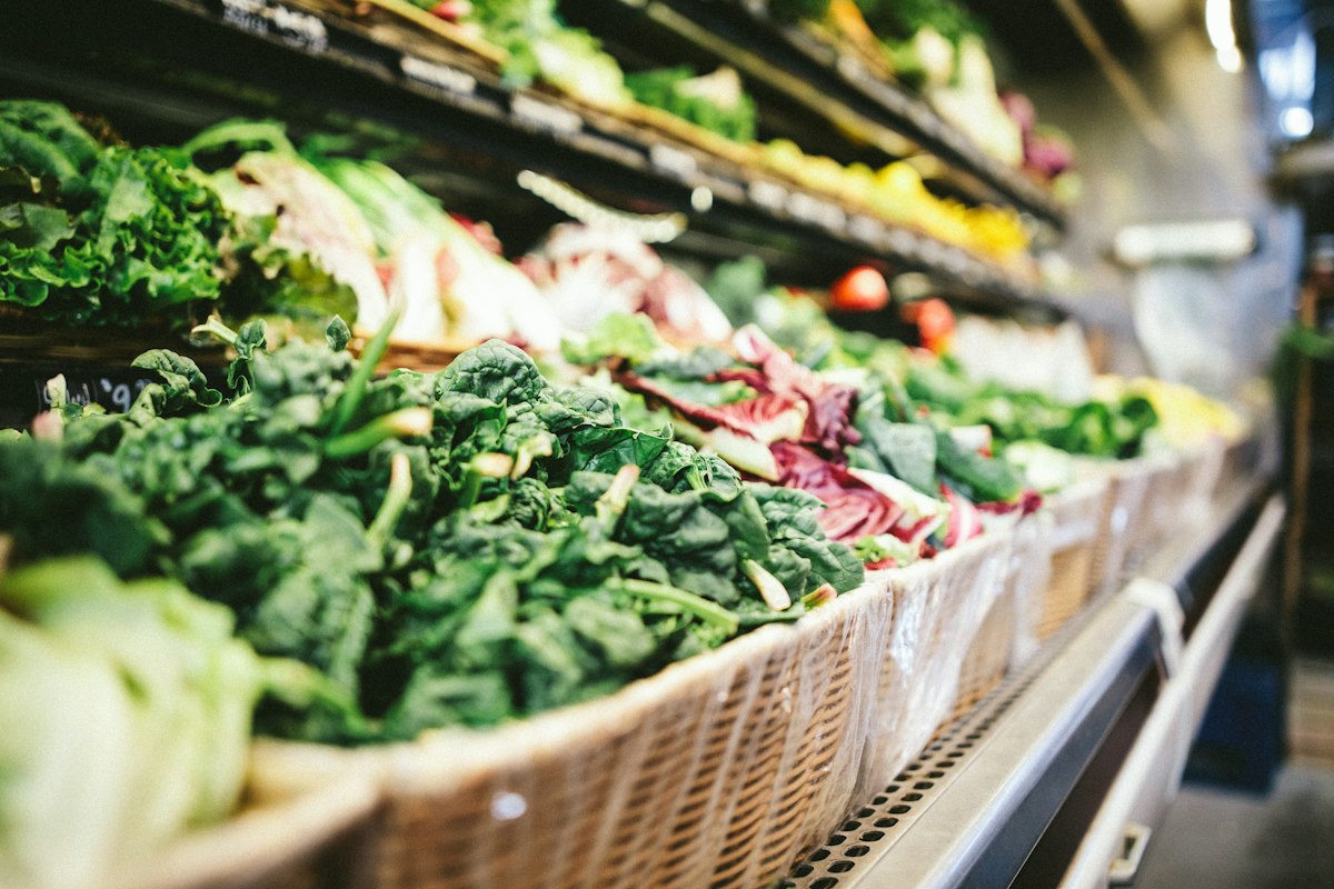 Person reviewing meal planning notes and food preparation strategies